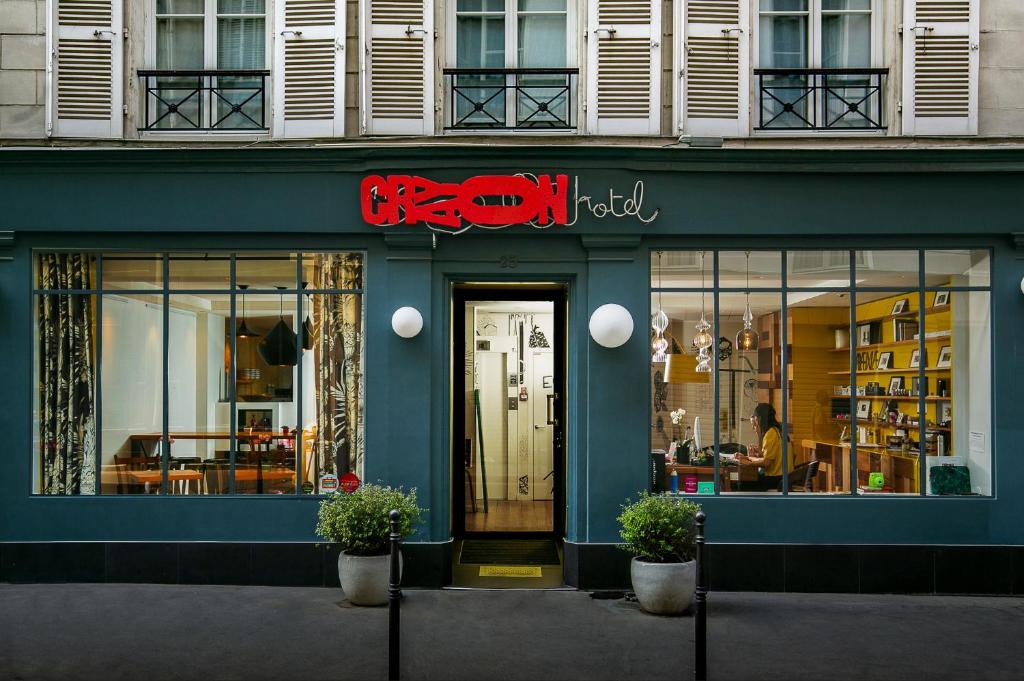 a store front of a building with a sign on it at Hôtel Crayon in Paris