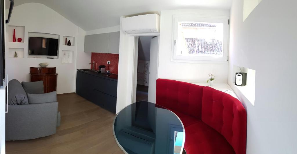 un salon avec un banc rouge et une table dans l'établissement Tetti Rossi, à Bologne