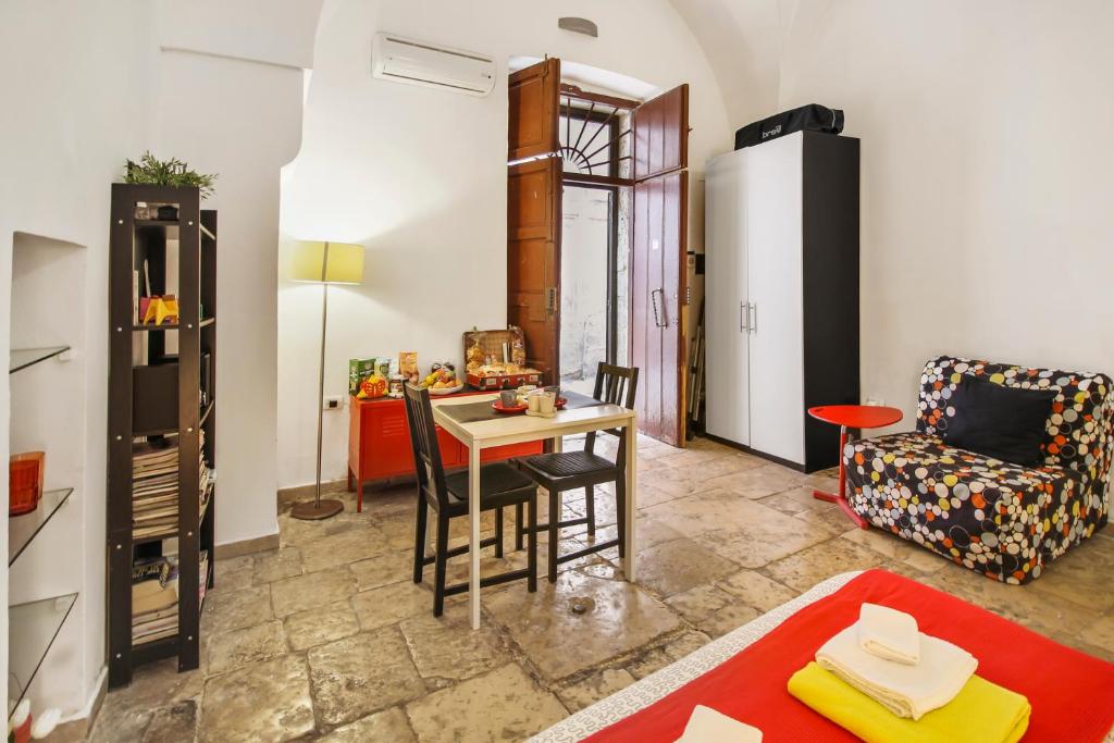 a living room with a table and a chair at B&B Affittacamere Del Teatro in Brindisi