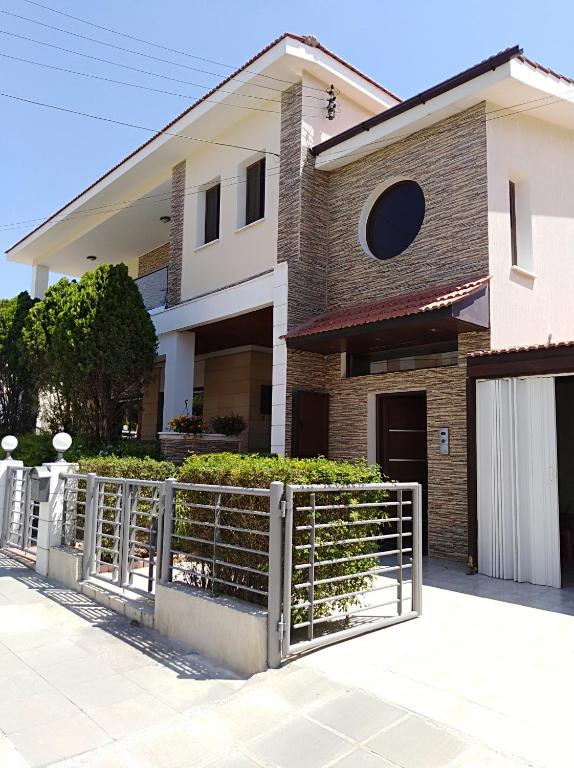 a house with a fence in front of it at Andros Residence in Limassol