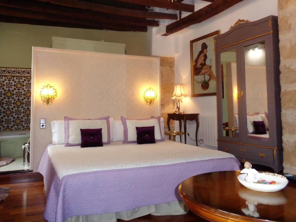 Postel nebo postele na pokoji v ubytování Hotel Boutique Nueve Leyendas