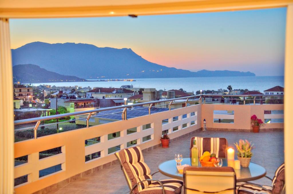 a balcony with a table and chairs and a view of the ocean at Kissamos View Apartment in Kissamos