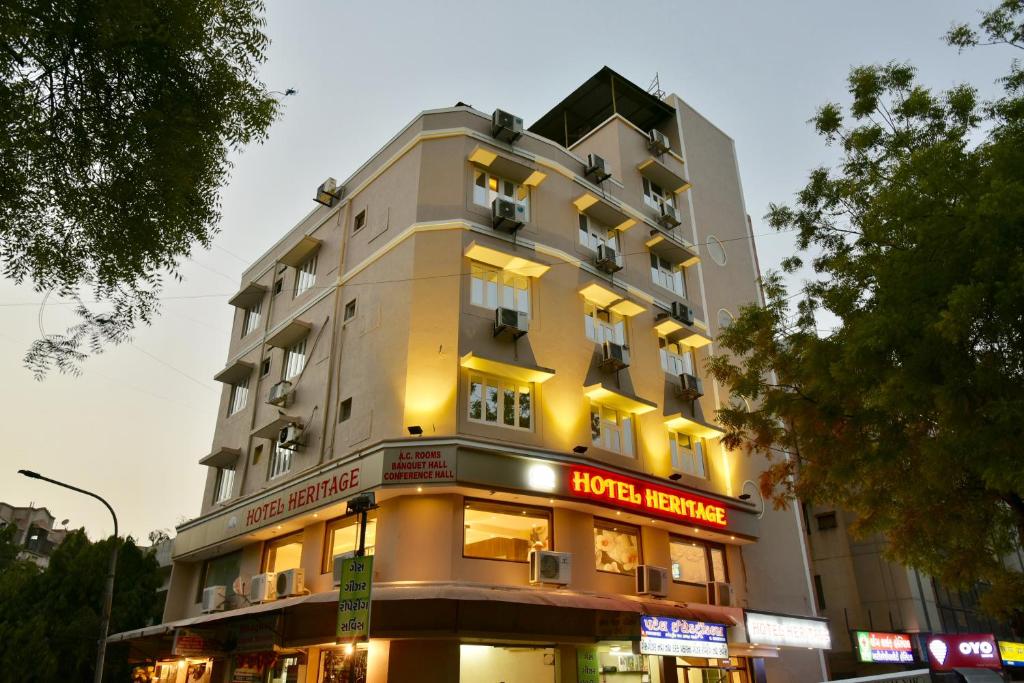 a tall building with a hotel heineken sign on it at Hotel Heritage - Near Navrangpura in Ahmedabad