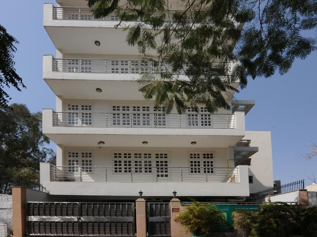 a tall white building with a lot of windows at Mehra Residency at The Airport in New Delhi