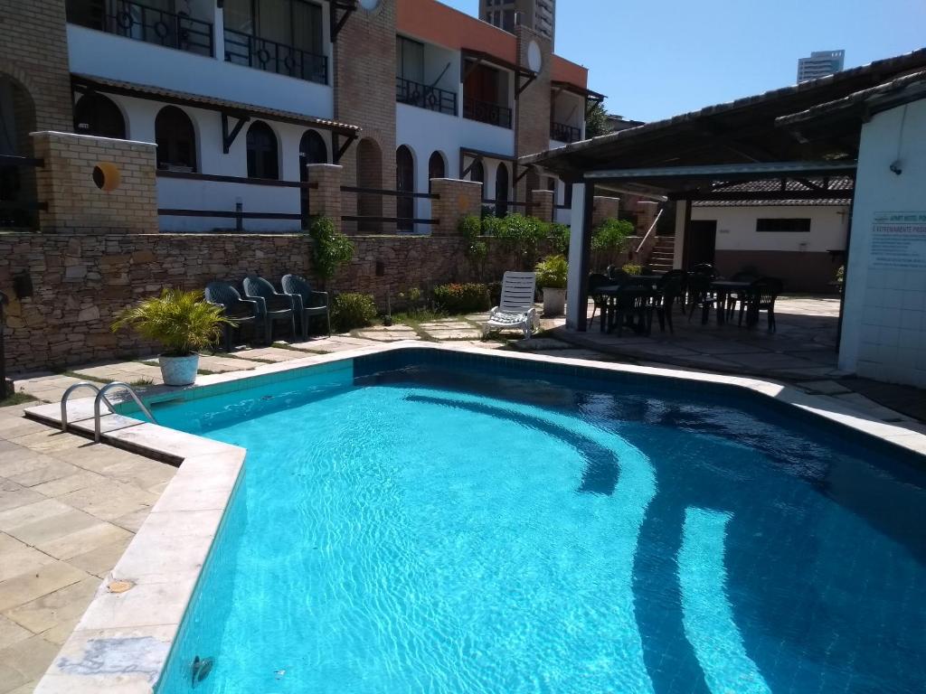 a swimming pool in the middle of a building at Apartamentos Ponta do Sol in Natal