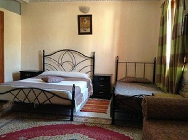 Postel nebo postele na pokoji v ubytování Hôtel Tijani