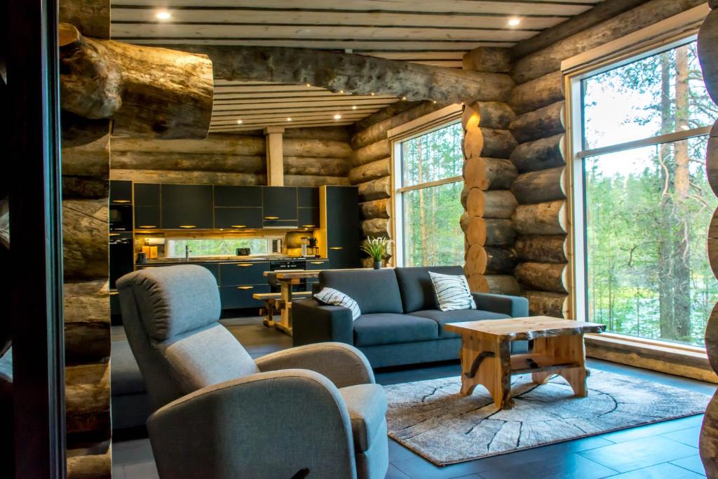 a living room with a blue couch and a table at Villa Konttaisenranta in Ruka