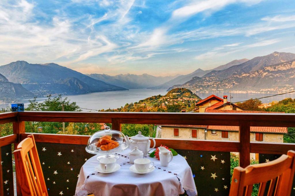 a table on a balcony with a view of a lake at Bellagio Les Etoiles in Bellagio