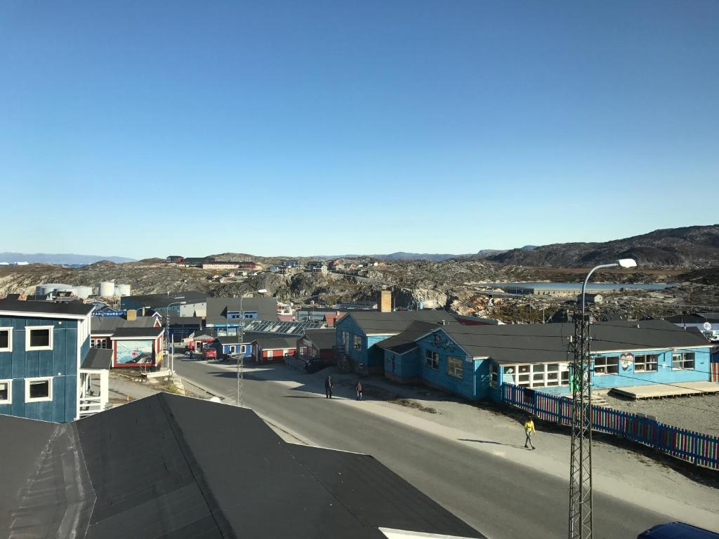 a small town with houses and a street at Hotel Nuka in Ilulissat