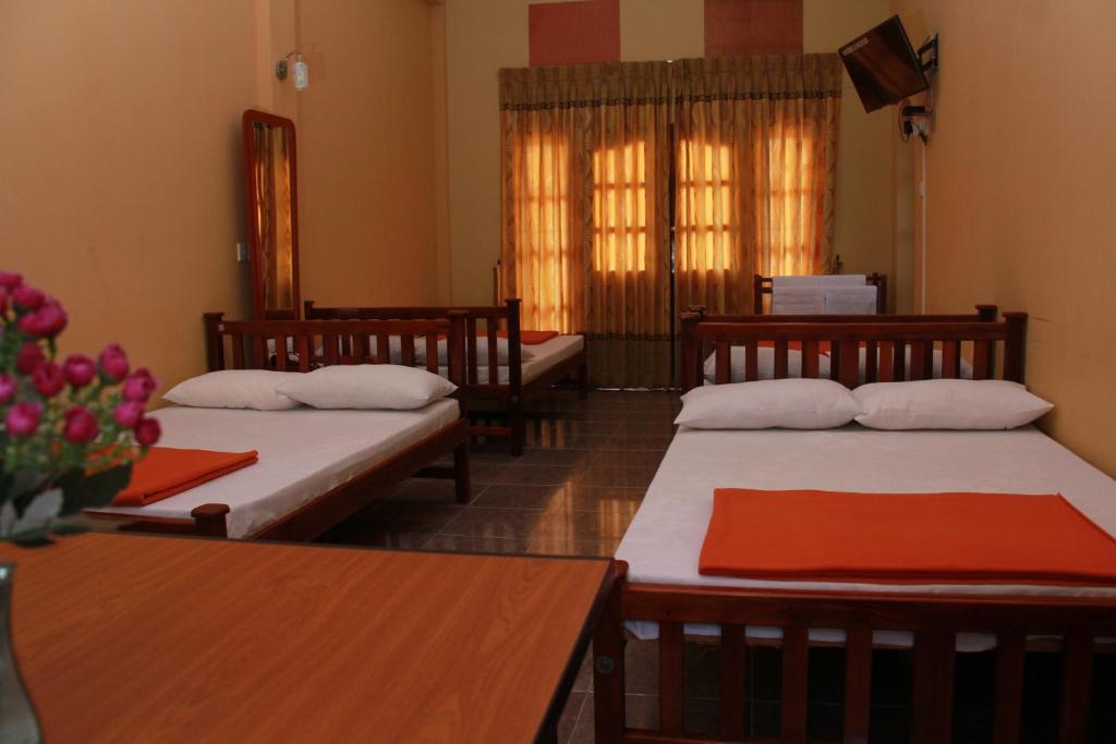 Postel nebo postele na pokoji v ubytování Anura Guest Inn