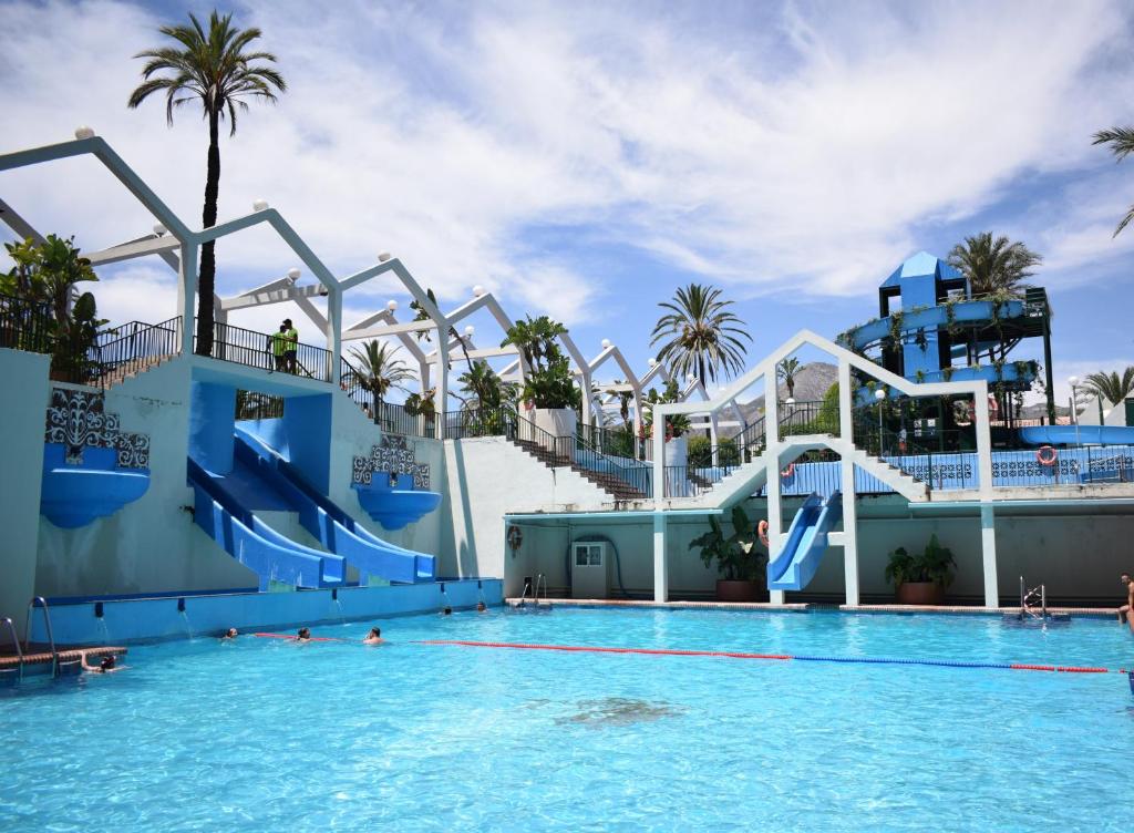 a large swimming pool with a water slide at Apartamentos Benal Beach Group in Benalmádena