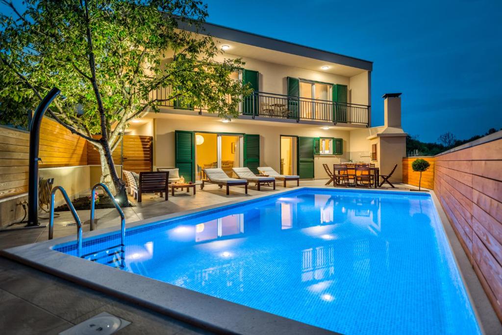 a swimming pool in front of a house at Villa Nika in Bisko