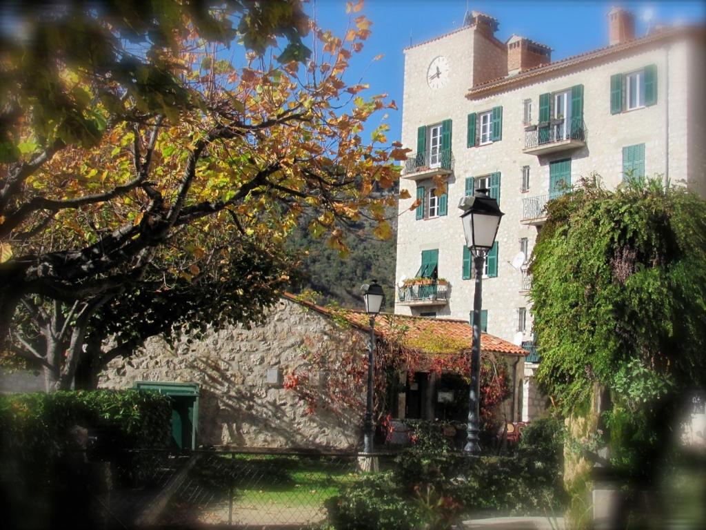 a building and a street light next to a building at Castillon - Maritime Alpes in Castillon