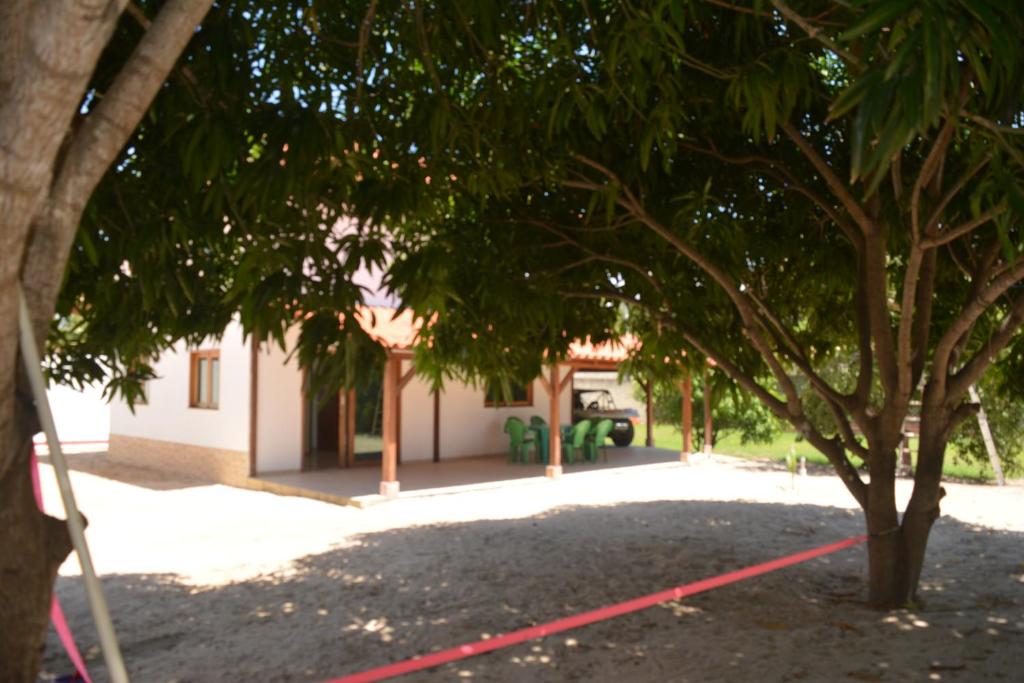 a tree with a red rope in front of a building at Casa do Sol in Paracuru