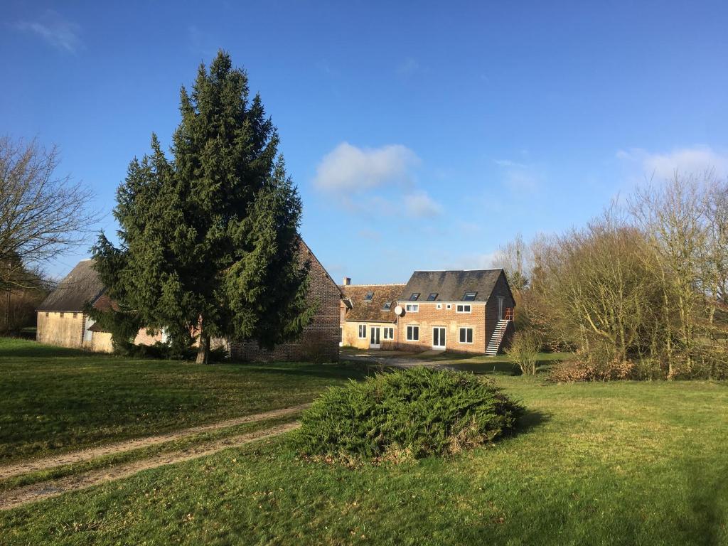 a large house in a field with a tree at ZenViewStudios in Saint-Agil