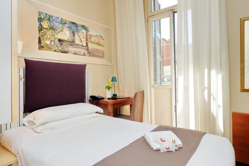 Postel nebo postele na pokoji v ubytování Hotel Camelia