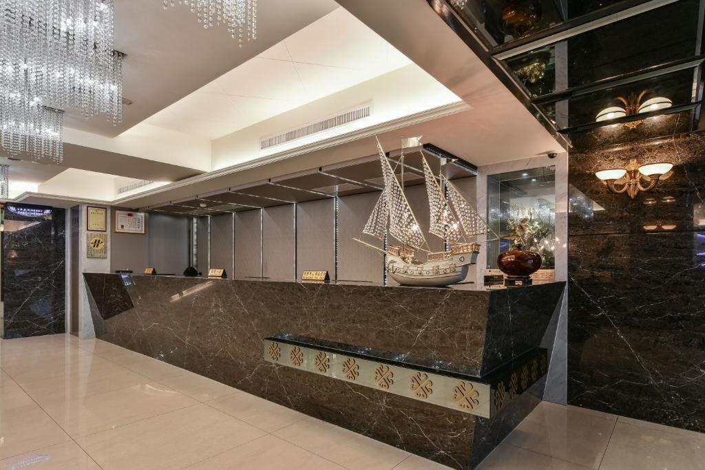 a lobby with a pirate ship on the wall at Harmonious Hotel in Kaohsiung