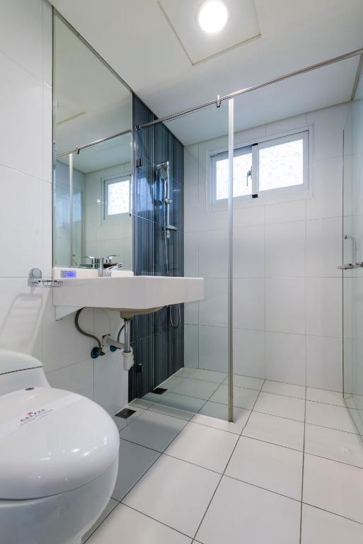 a bathroom with a toilet and a sink and a shower at Harmonious Hotel in Kaohsiung