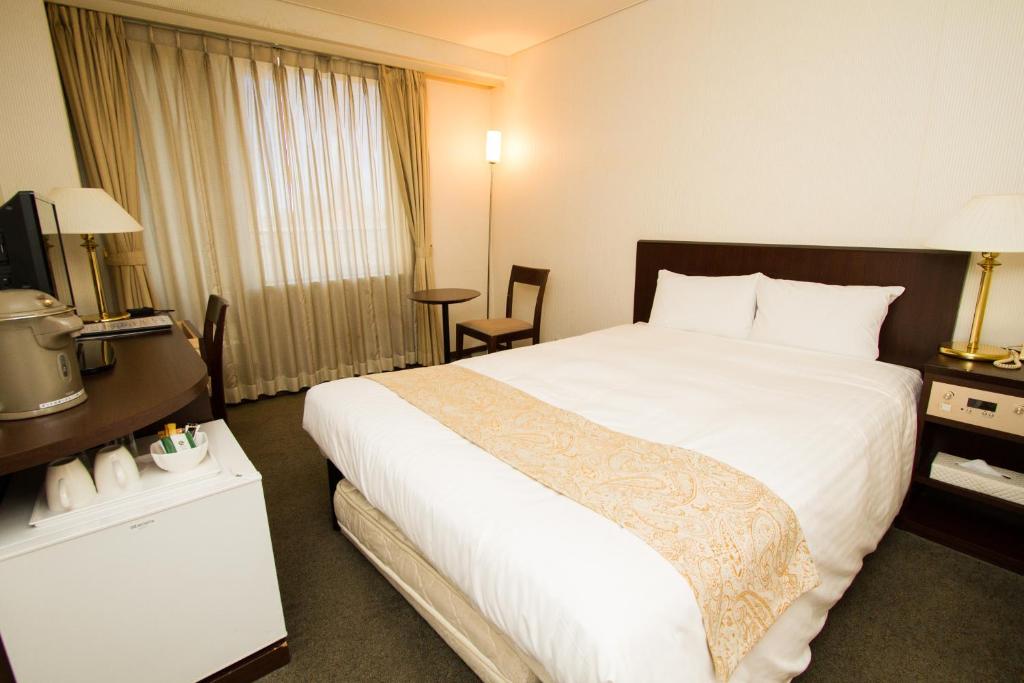 Postel nebo postele na pokoji v ubytování Hotel Yokohama Camelot Japan