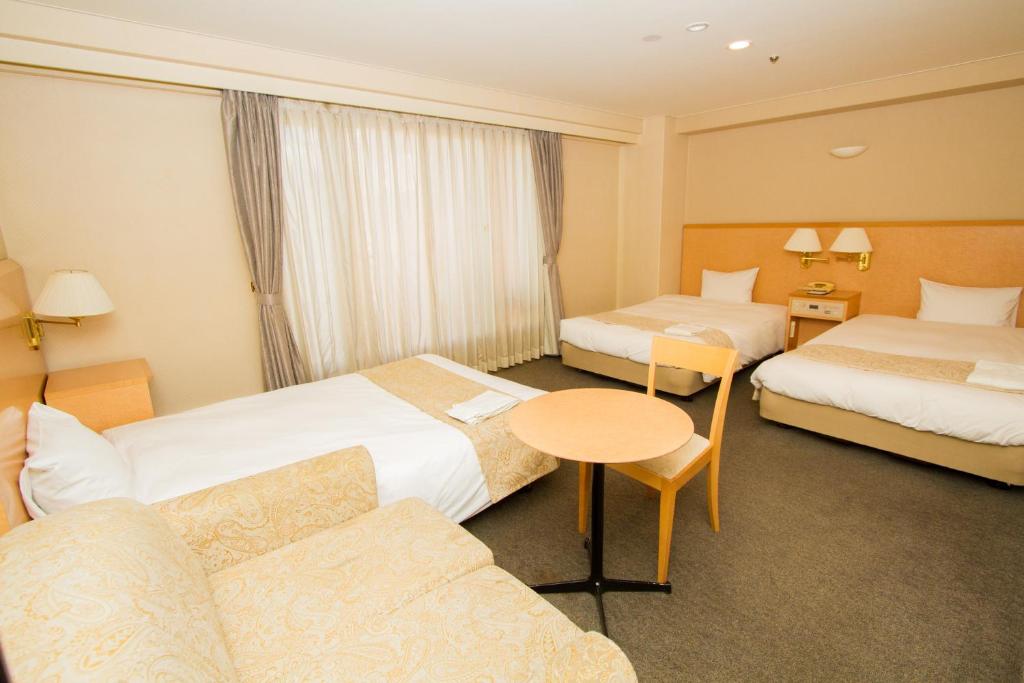 Postel nebo postele na pokoji v ubytování Hotel Yokohama Camelot Japan