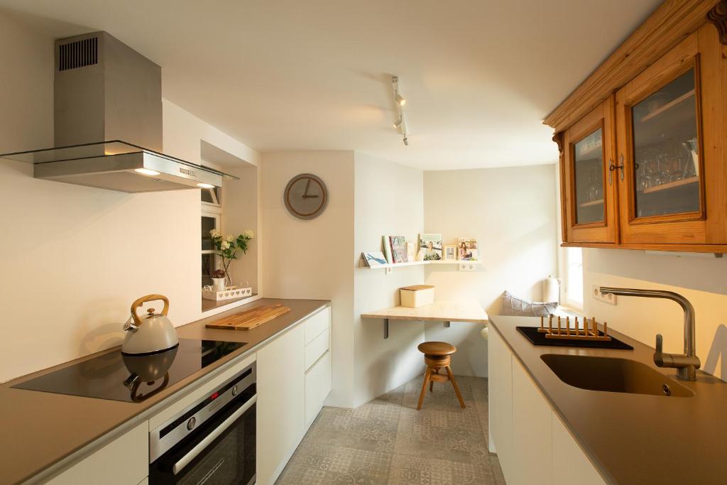 a kitchen with white cabinets and a sink and a counter at Ferienwohnung Gerberstube, 100m vom See in Überlingen