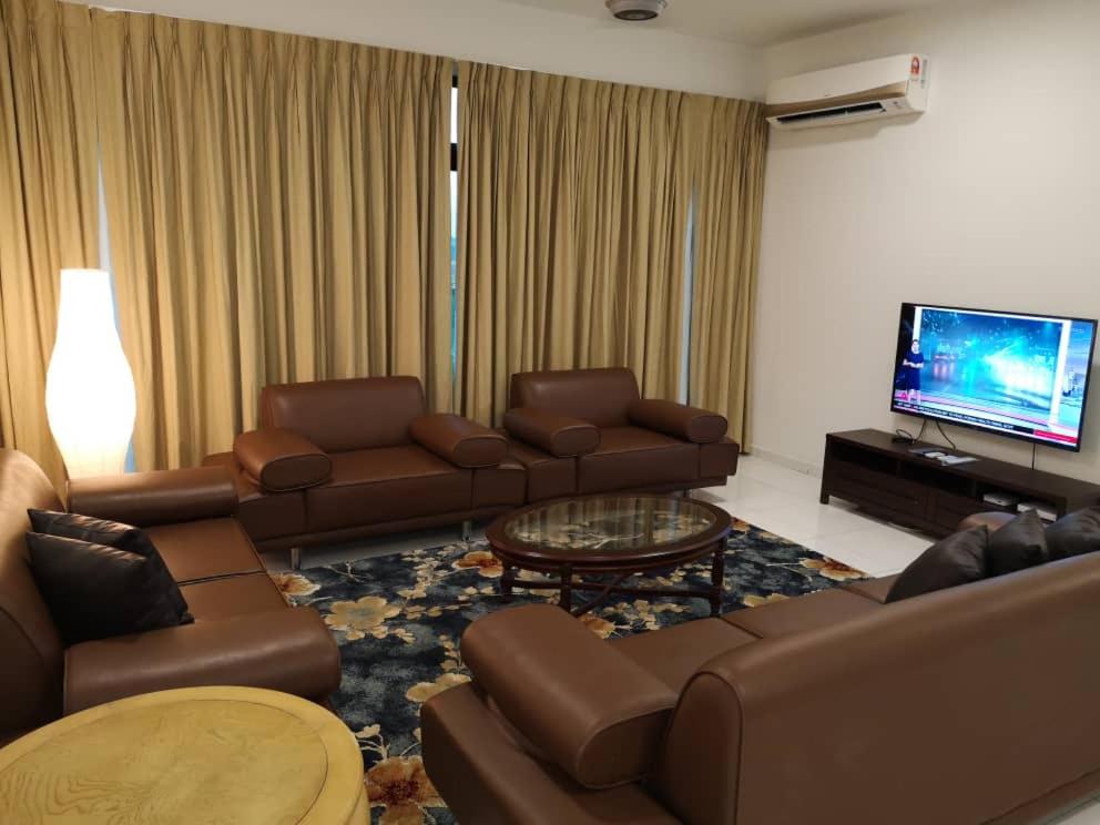 a living room with couches and a flat screen tv at Skyloft Muslim Suite in Johor Bahru