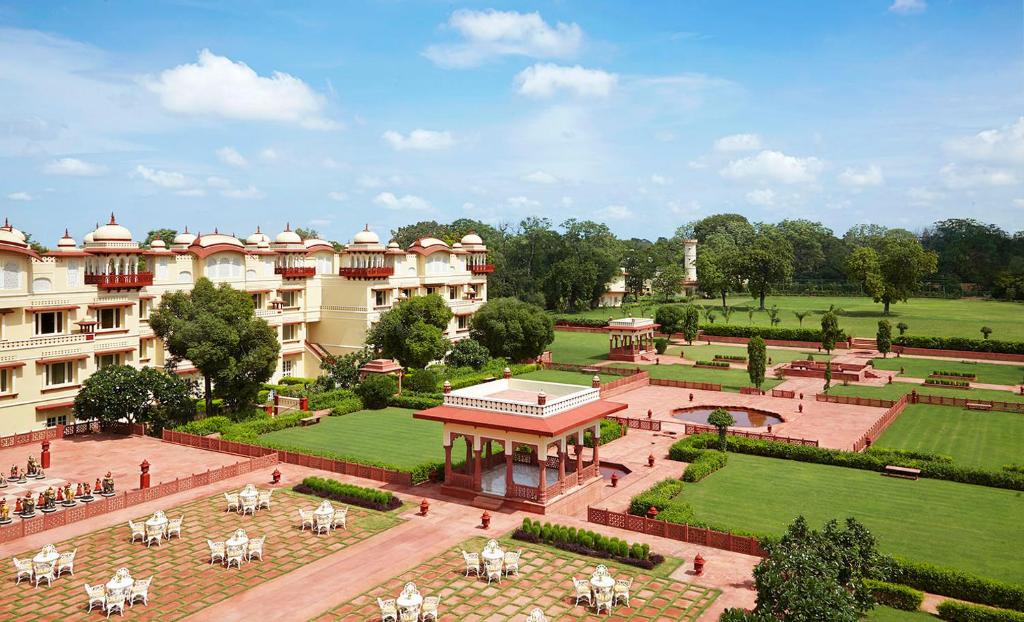a large building with a garden and a courtyard at Jai Mahal Palace in Jaipur