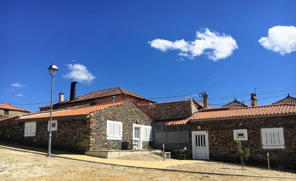 a group of brick buildings with a blue sky at Desafios da Horta in Souto da Velha