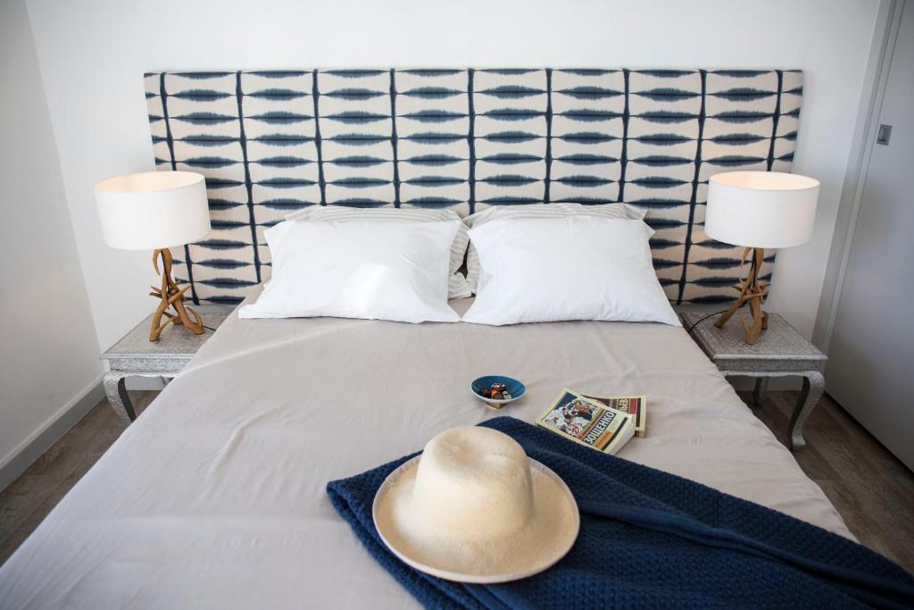 a hat sitting on a bed with two lamps at Apt. Downtown 2 in Funchal