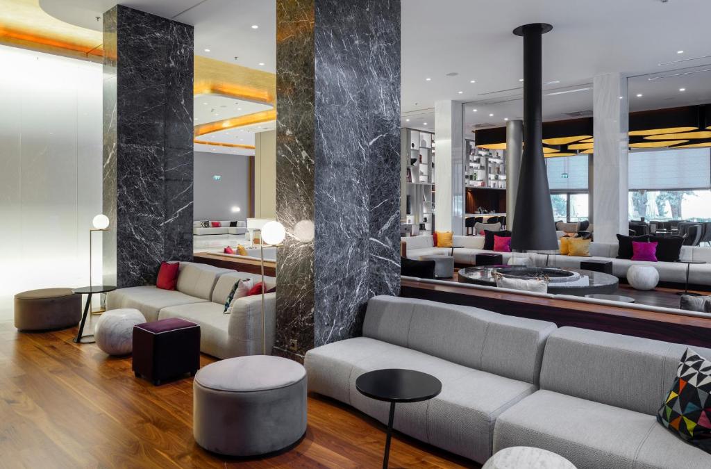 a living room with two couches and a lobby at Makedonia Palace in Thessaloniki