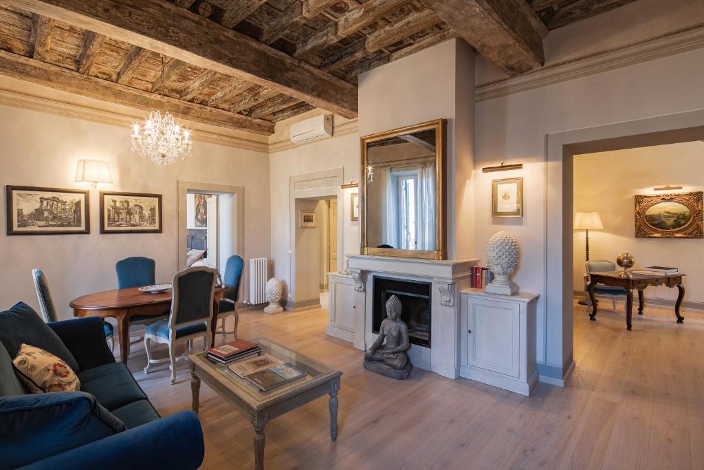 uma sala de estar com uma lareira e uma mesa em La Casa di Lucia em Cortona
