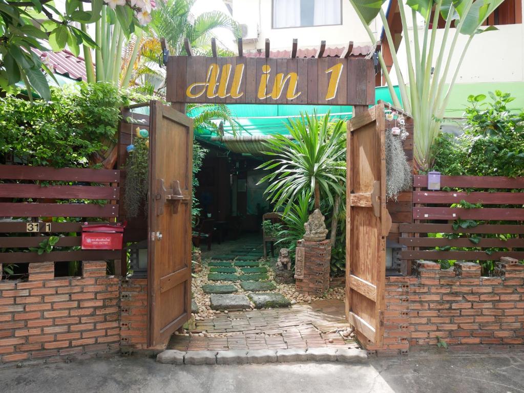 an open gate with a sign that reads all in z at All in 1 Guesthouse in Chiang Mai