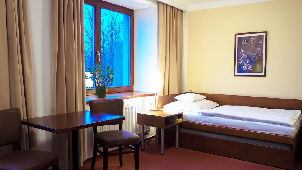 Postel nebo postele na pokoji v ubytování Hotel Cvilín