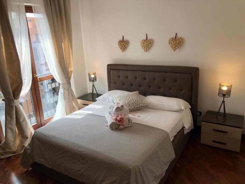 a bedroom with a bed with two teddy bears on it at Perugino Apartments in Fiumicino