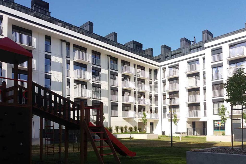 a large building with a playground in front of it at Very Berry - Zwierzyniecka 30 - check in 24h, parking, lift in Poznań
