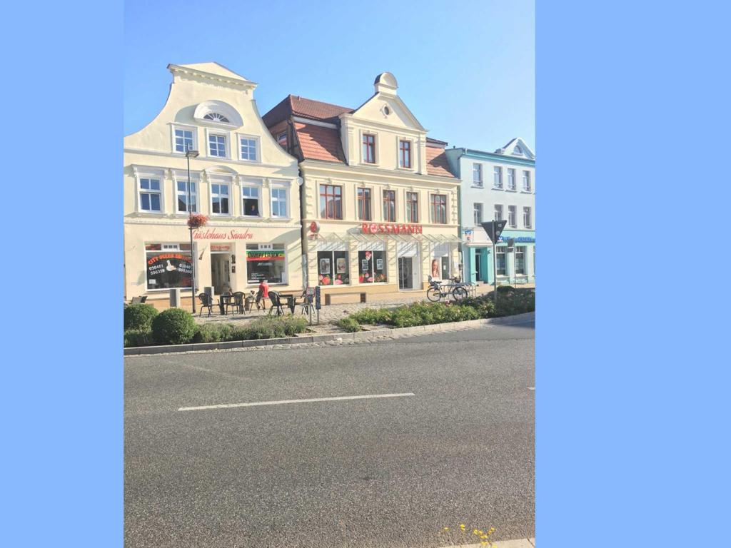 a row of houses on the side of a street at Gaestehaus _ Sandra Objekt _ 90541 in Bützow