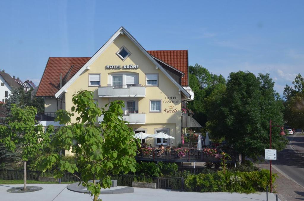 a large yellow building with a sign on it at Hotel & Restaurant KRONE in Kressbronn am Bodensee
