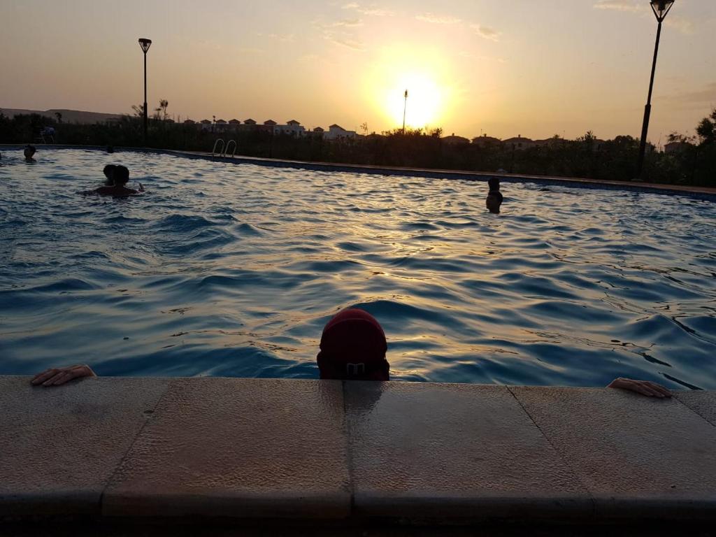 a group of people swimming in a swimming pool at FamilyConfort Saidia in Saïdia