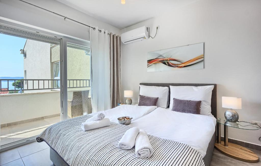 1 dormitorio con 1 cama grande y toallas. en Modern apartments with sea view 150 meters to beach, en Kaštela