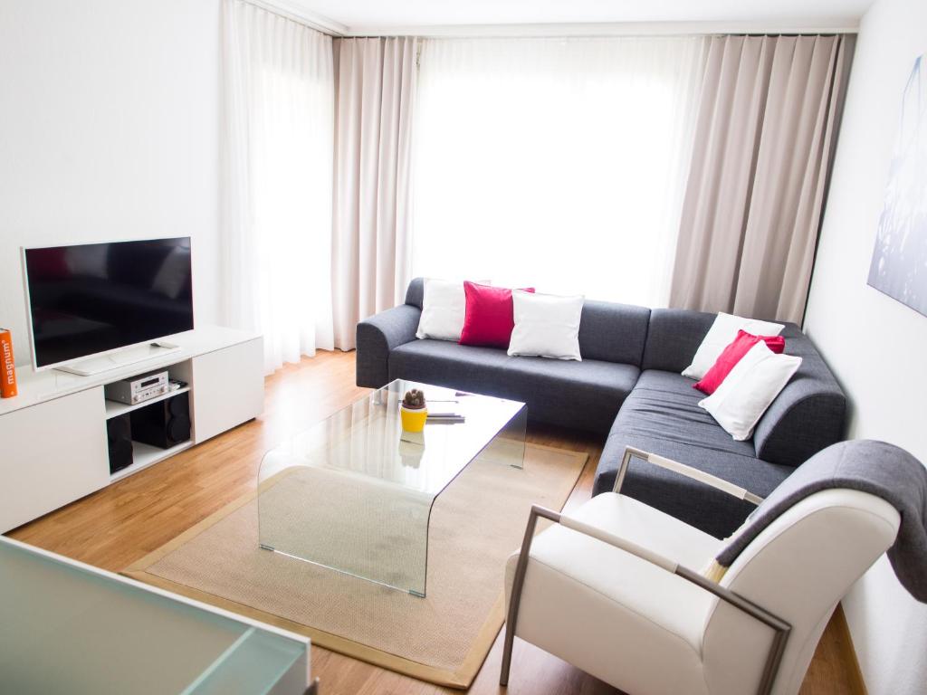 a living room with a couch and a table at CITY STAY - Ringstrasse in Brüttisellen