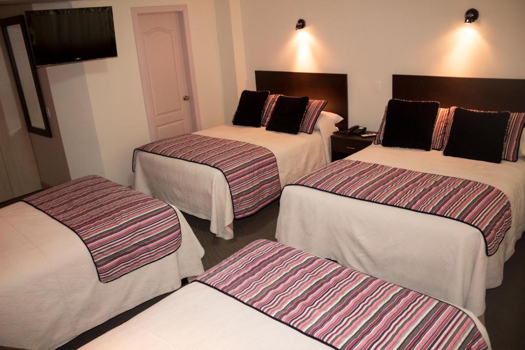 Postel nebo postele na pokoji v ubytování Hotel Novalux