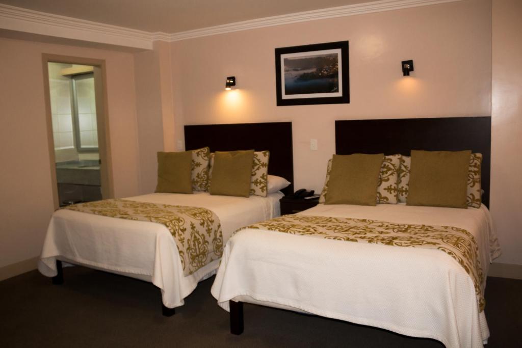 Postel nebo postele na pokoji v ubytování Hotel Novalux