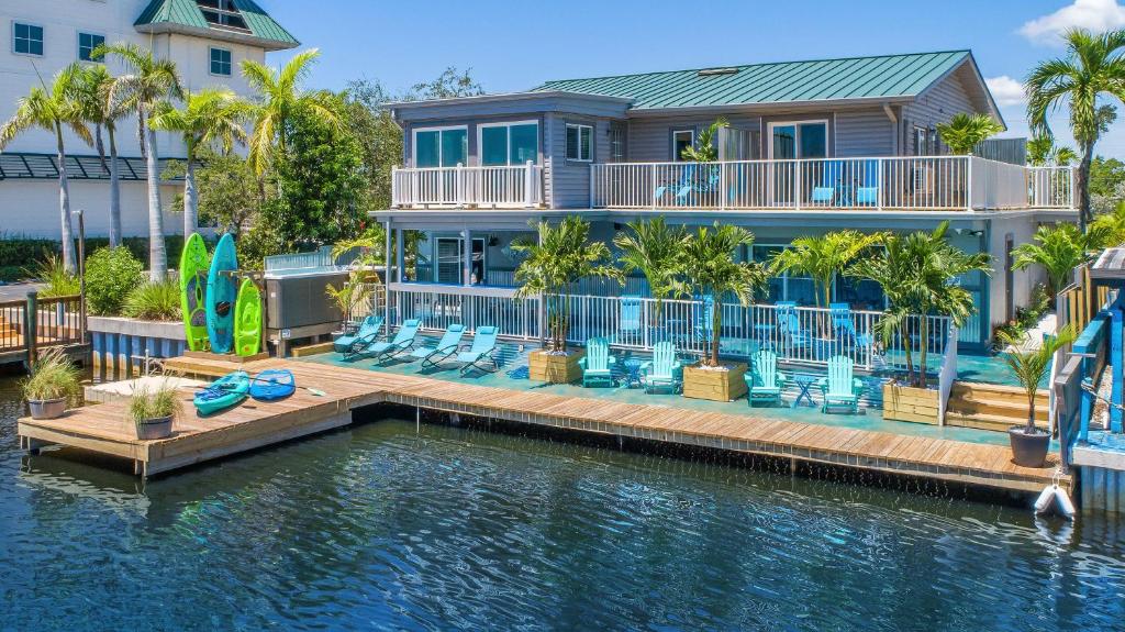 a house with a dock in the water at Latitude 26 Waterfront Boutique Resort - Bonita Springs in Bonita Springs