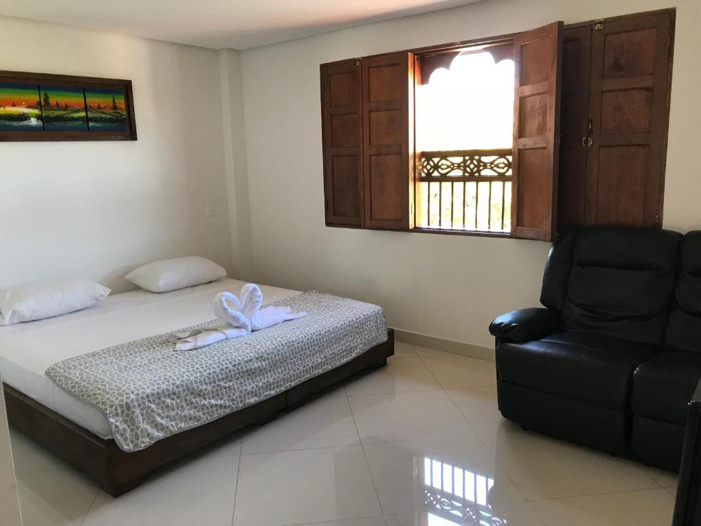 Postel nebo postele na pokoji v ubytování Hotel Bahia Guatape