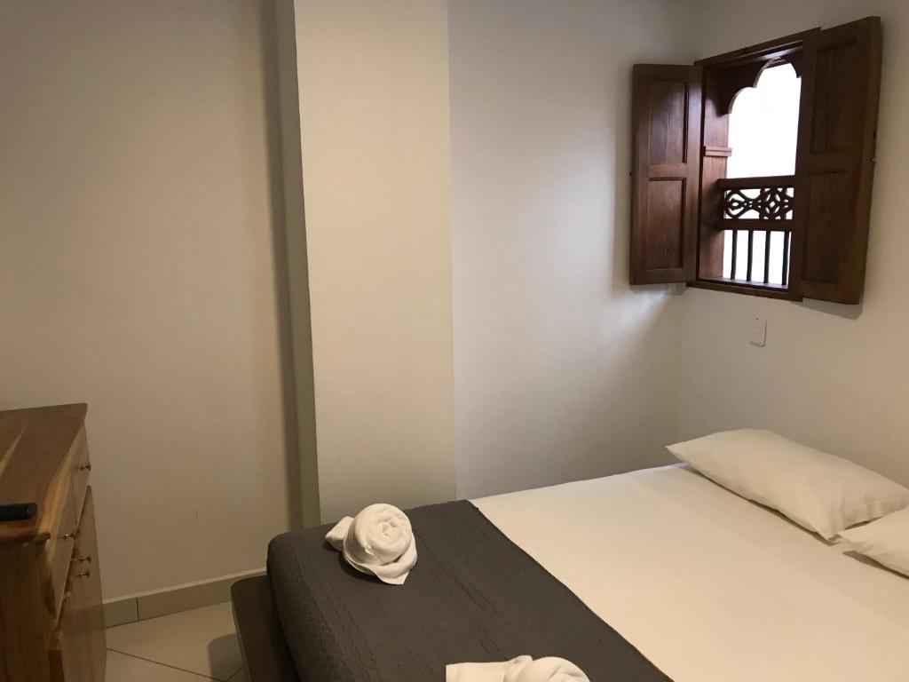 Postel nebo postele na pokoji v ubytování Hotel Bahia Guatape