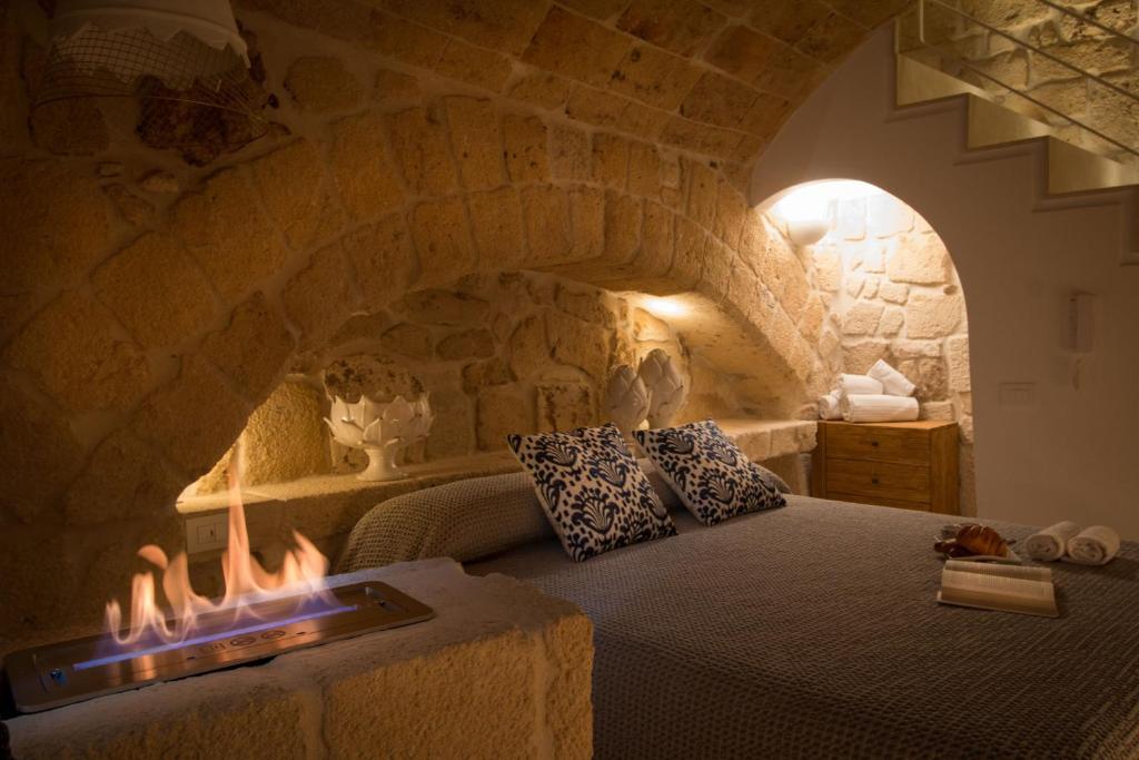 a bedroom with a bed with a stone wall at Casa Regina Paola in Monopoli