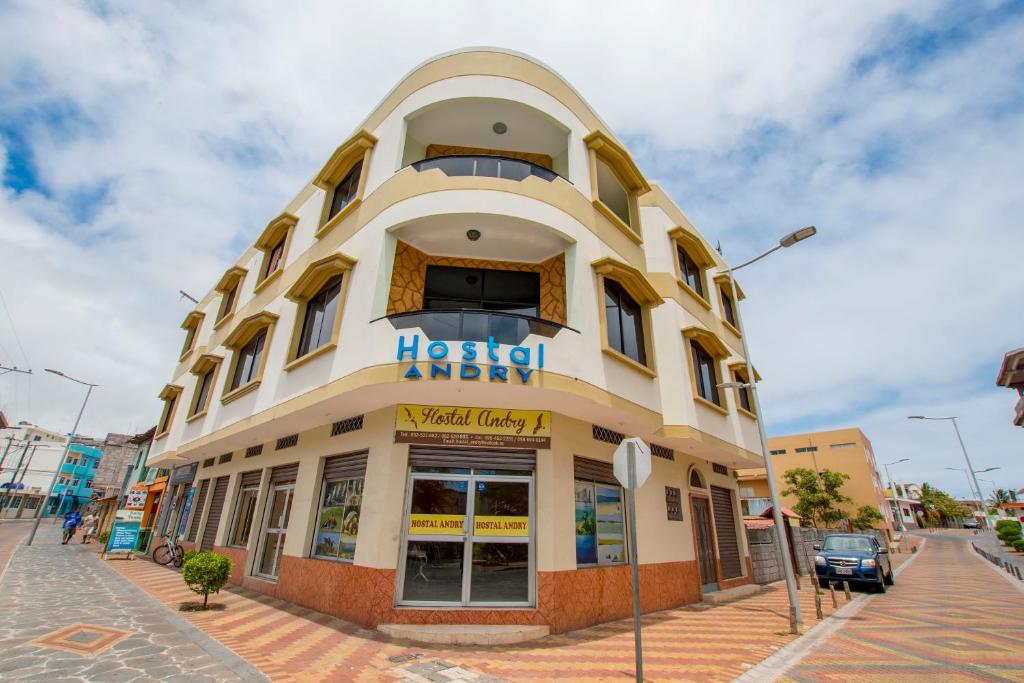 a building with a hotel agency sign on it at Hostal Andry in Puerto Baquerizo Moreno