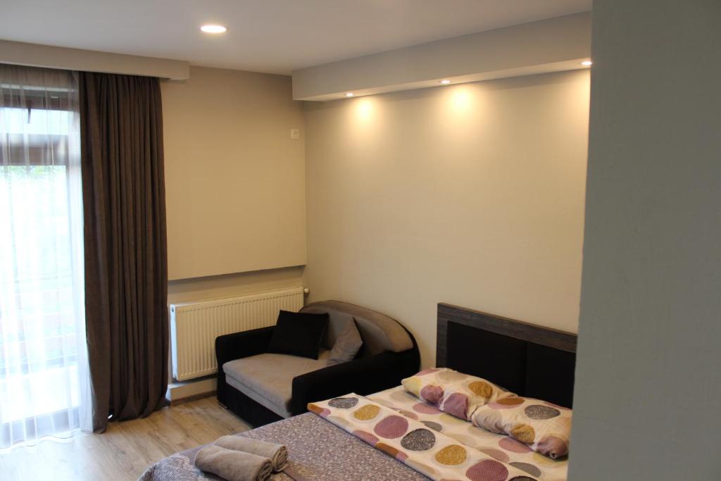 a living room with a couch and a chair at Guest House on Meskheti in Borjomi