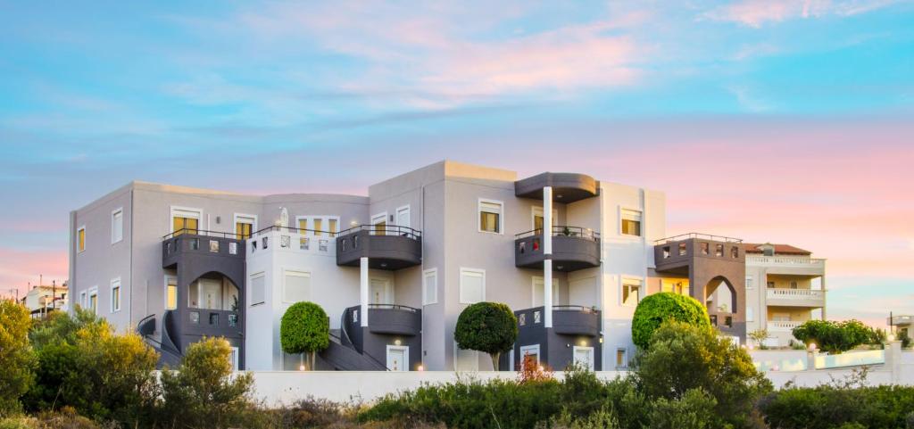a building with balconies on the side of it at Talos Luxury Suites in Kounoupidhianá