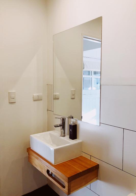 a bathroom with a white sink and a mirror at El Establo in Puerto Natales